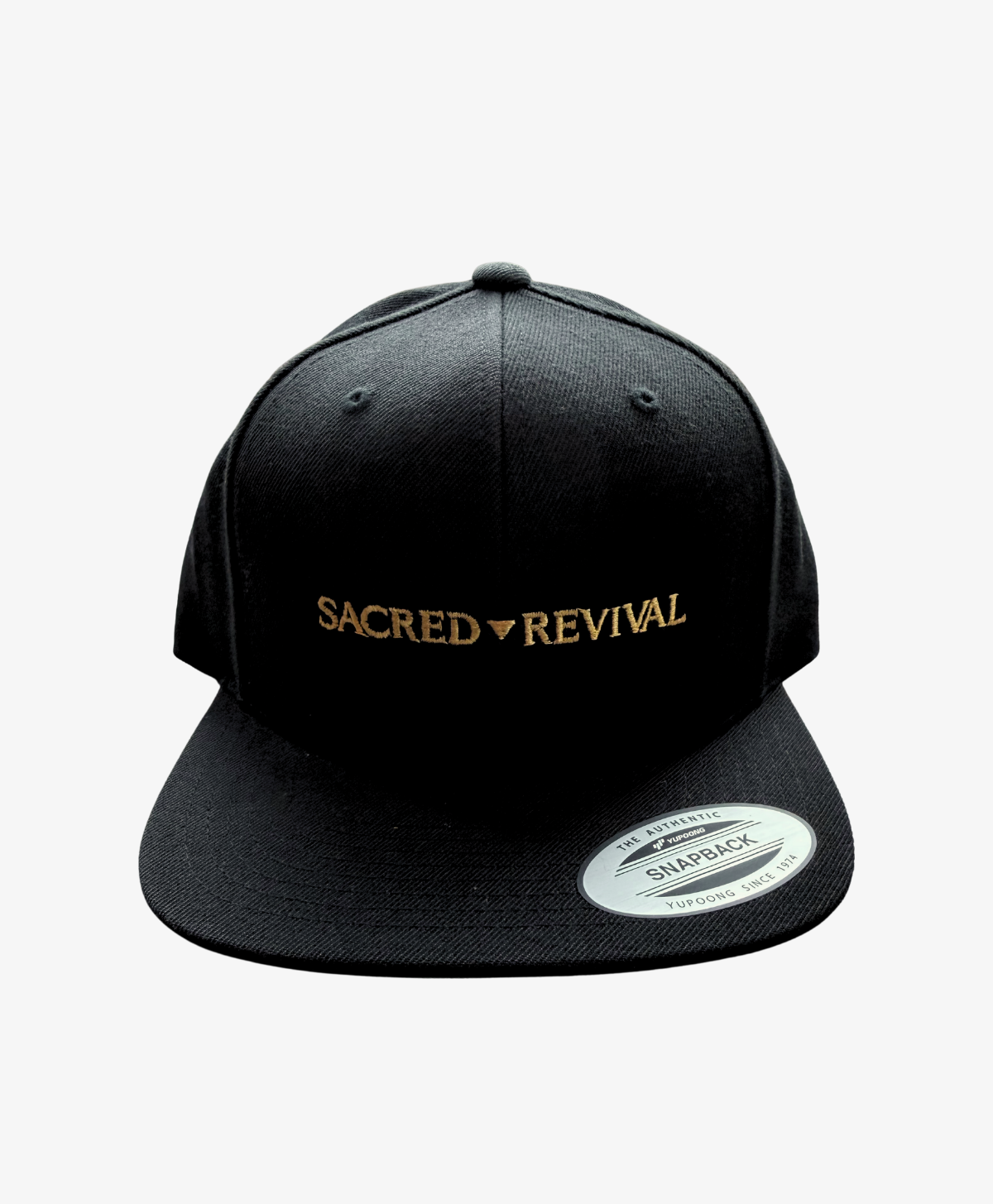 Black Sacred Revival snapback cap, front view, with the wordmark embroidered in gold