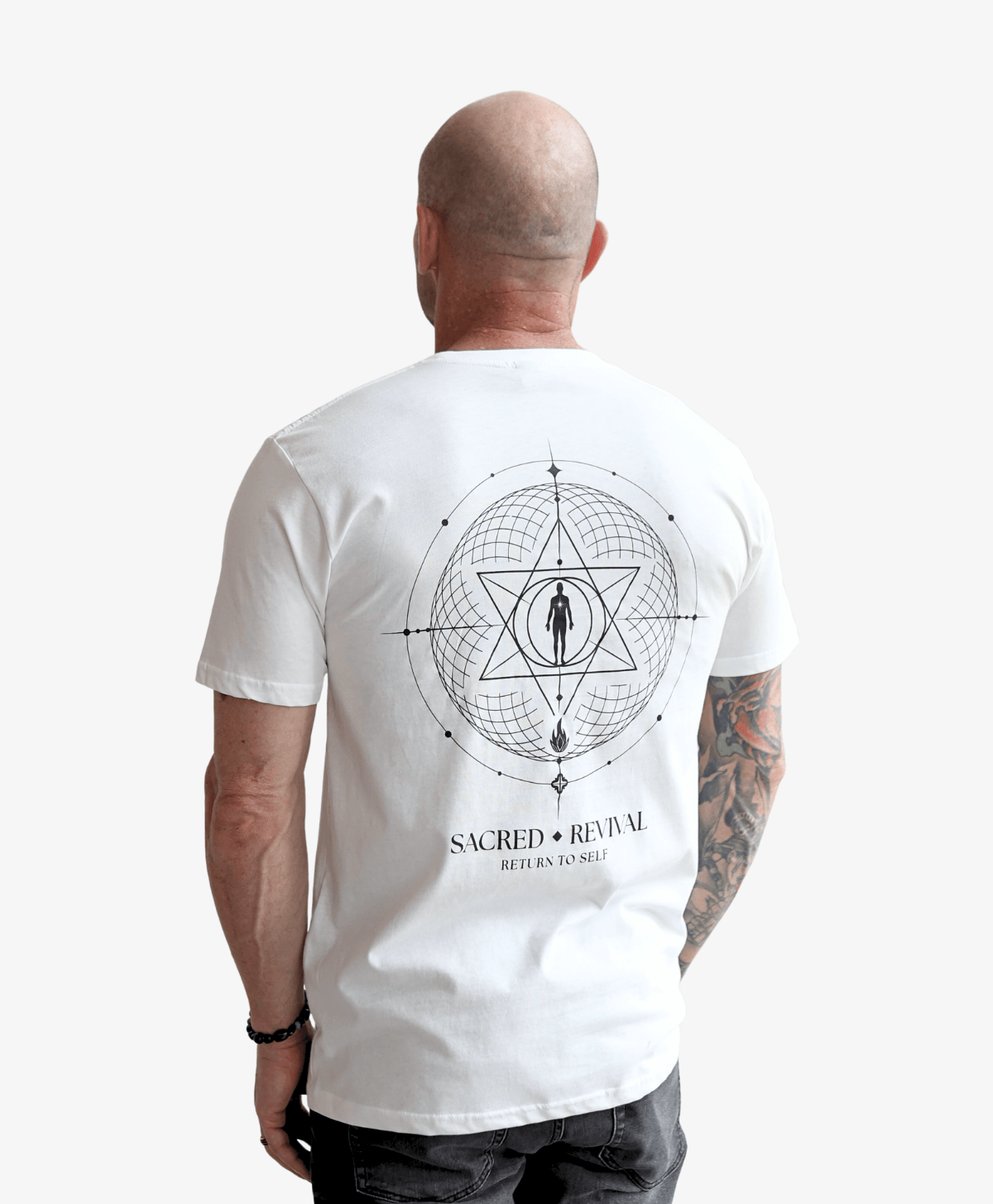 Man seen from behind wearing the white Return to Self tee