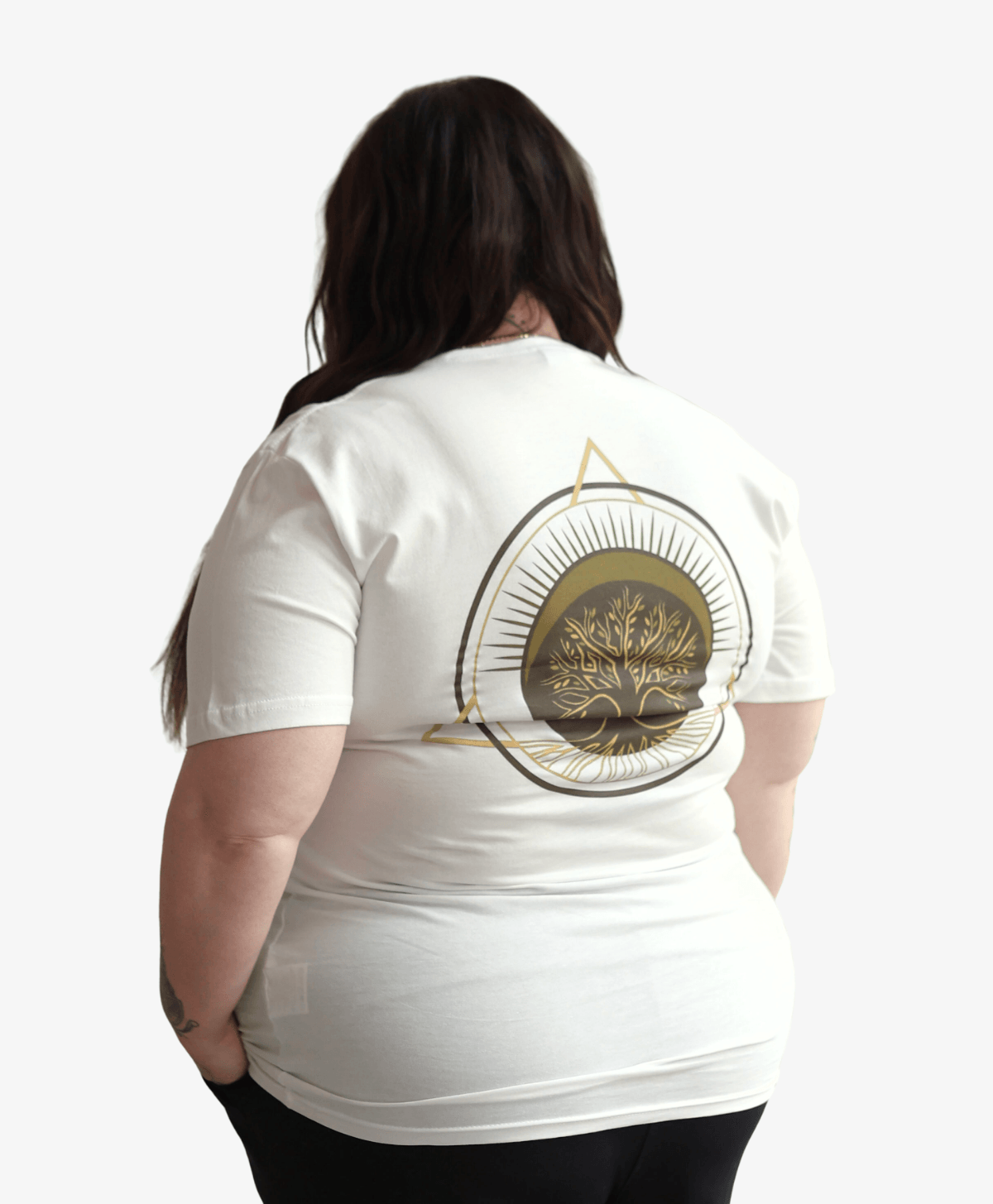 Woman seen from behind wearing the white Tree of Life tee with the full-colour symbol