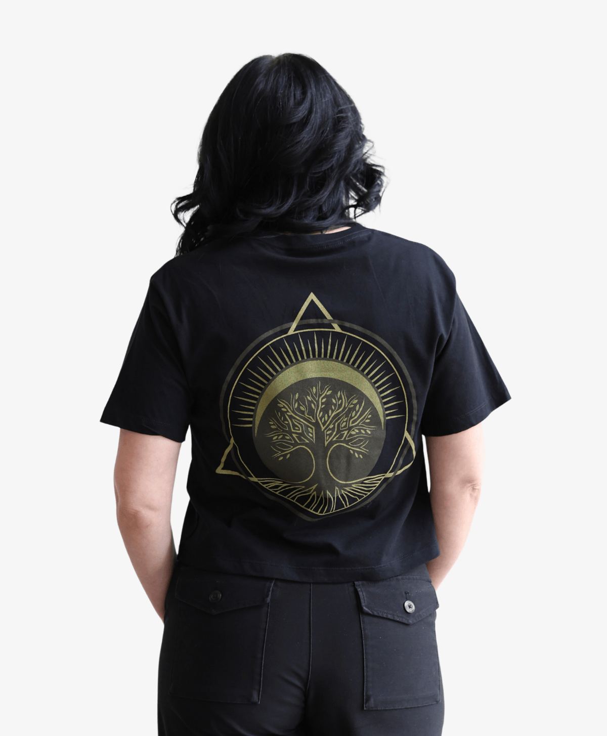 Woman seen from behind wearing the black Tree of Life boxy tee, full-length view