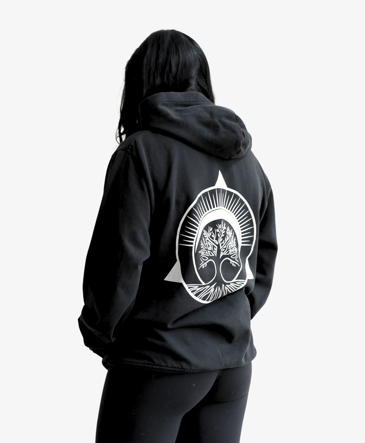 Person seen from behind wearing the black Tree of Life hoodie