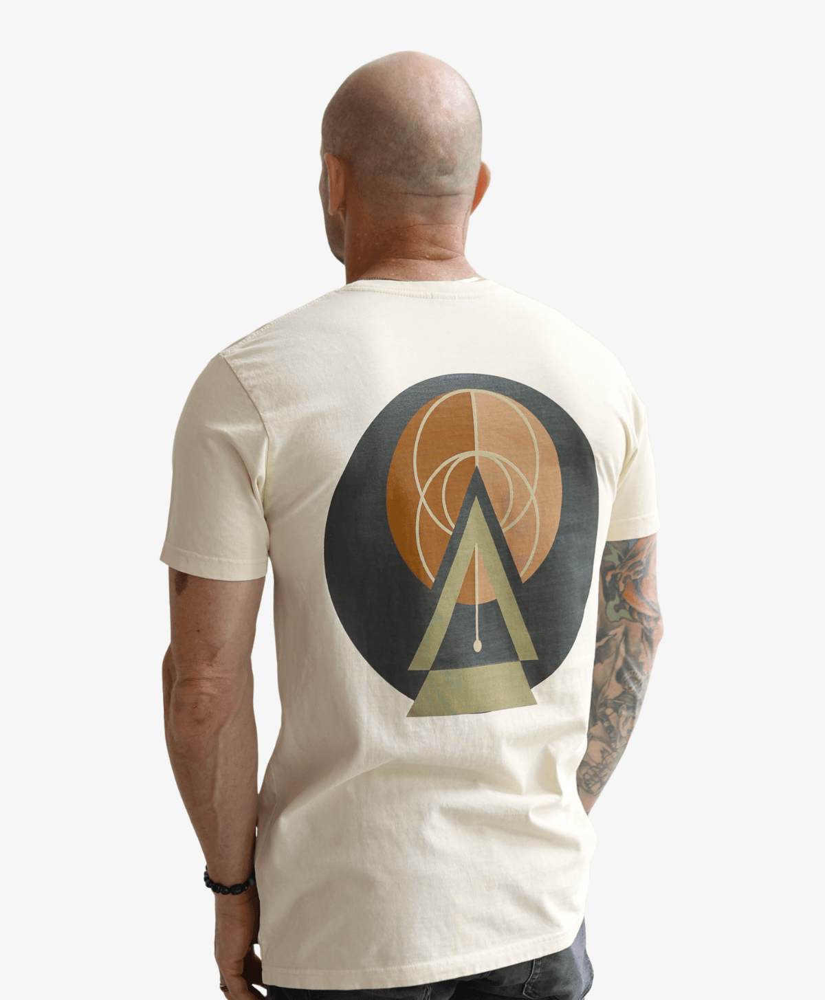 Man seen from behind wearing the cream Balanced tee