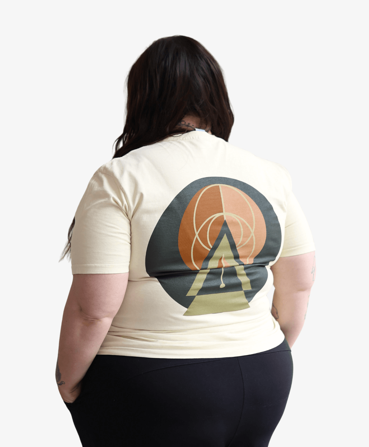 Woman seen from behind wearing the cream Balanced tee