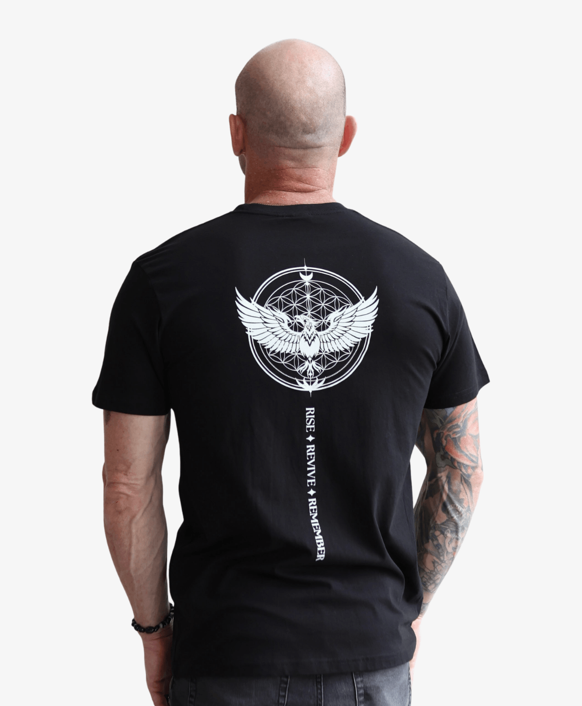 Man seen from behind wearing the black Phoenix Rising tee