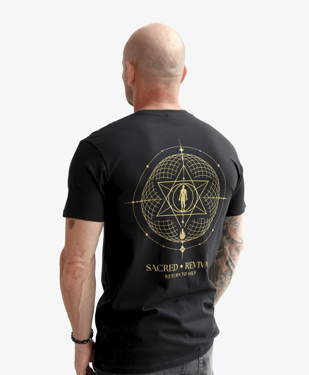 Man seen from behind wearing the black Return to Self tee