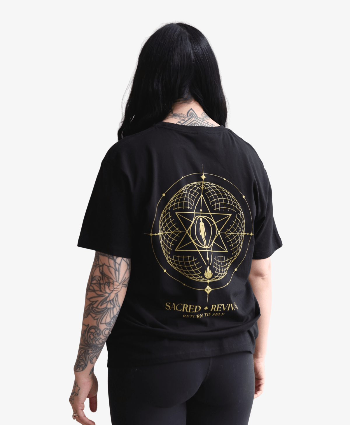Woman seen from behind wearing the black Return to Self tee
