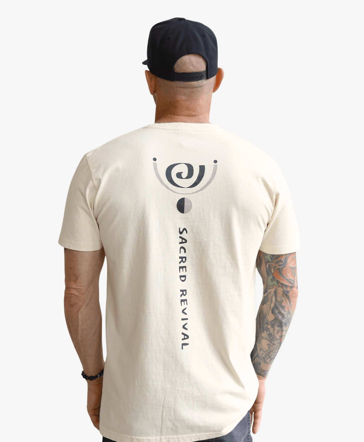 Man seen from behind wearing the cream Spiral tee