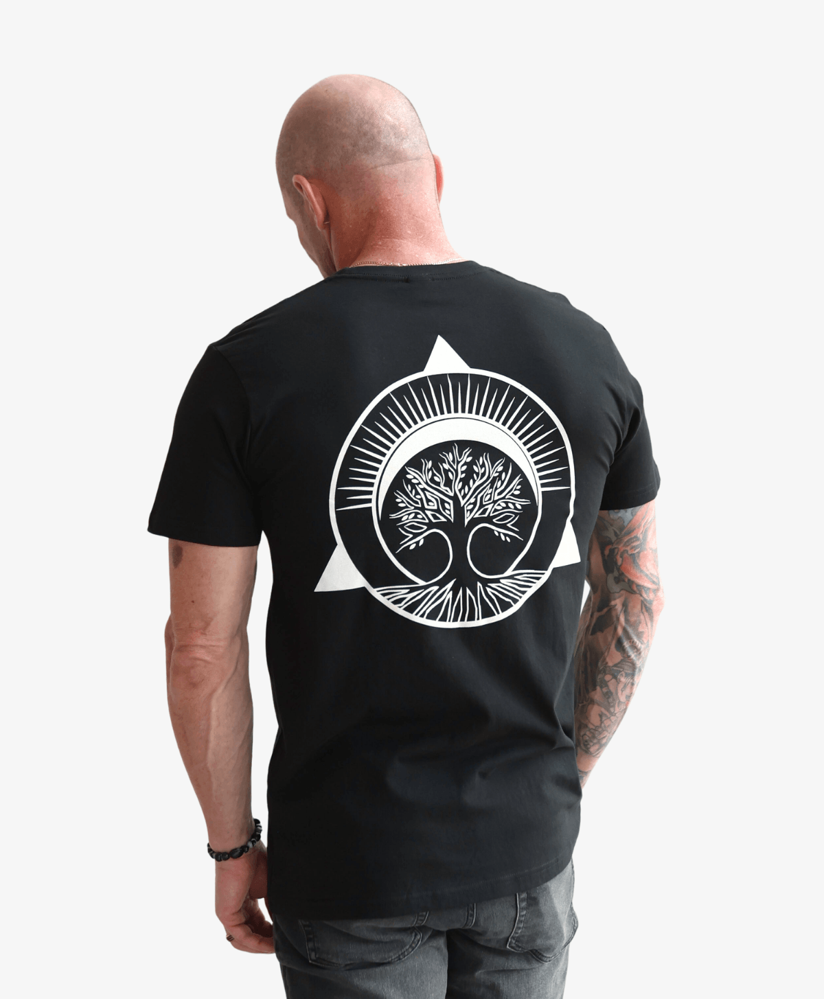 Man seen from behind wearing the black Tree of Life tee