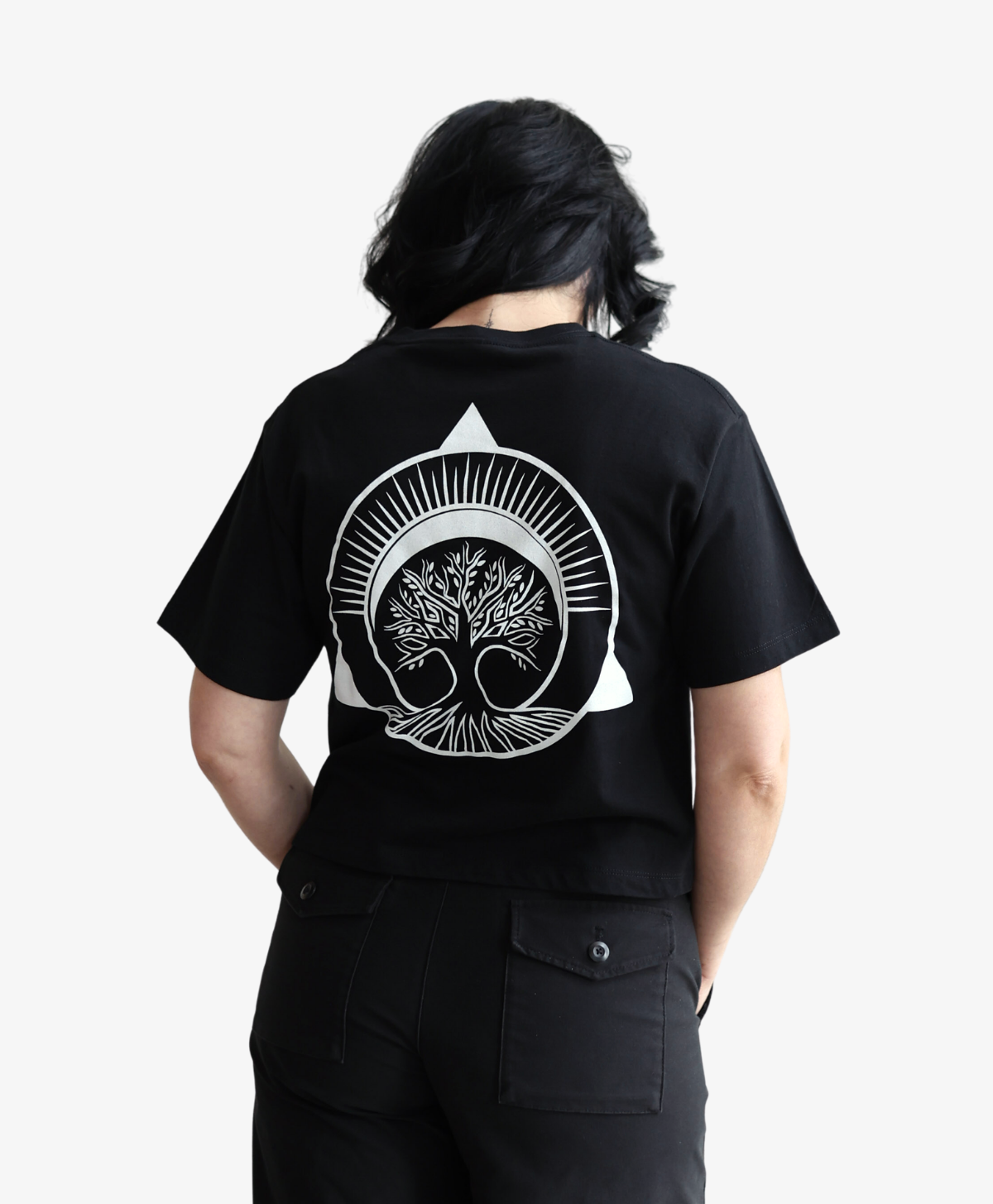Woman seen from behind wearing the black Tree of Life tee